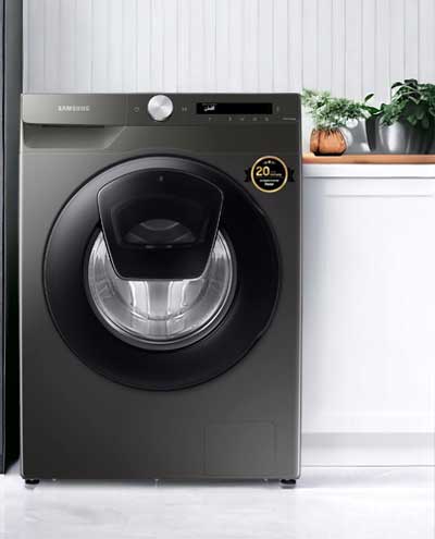 Black front load commercial washing machine in laundary area