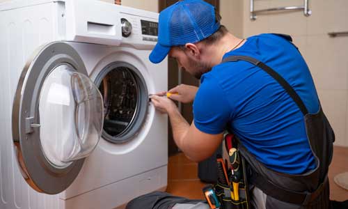 A technician fixing washing machine