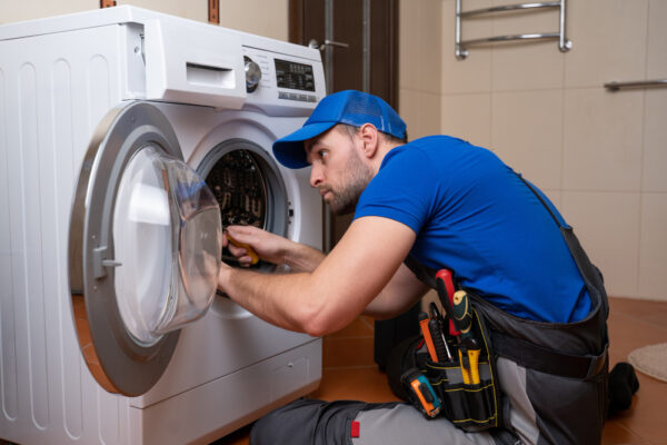 A technician installing washing machine in dubai