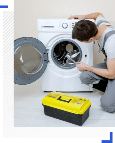 Washing machine repair technician fixing built in washing machine in dubai