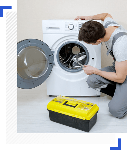 Washing machine repair technician fixing built in washing machine in dubai